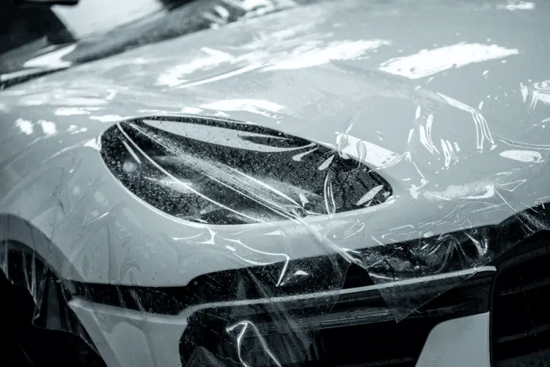Application of a full blue auto wrap PPF in a labor-intensive session; 